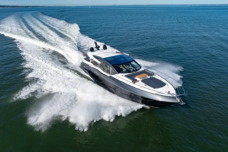 Slide: The Image of 2020 Sunseeker Predator 74 yacht cruising on open water, creating a dynamic wake. - 20