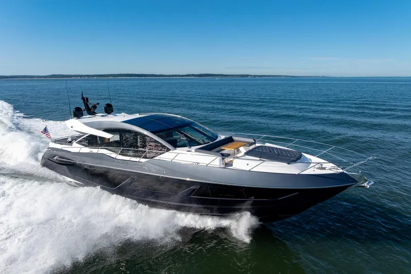 Slide: The Image of 2020 Sunseeker Predator 74 yacht cruising on open sea under clear blue sky. - 21