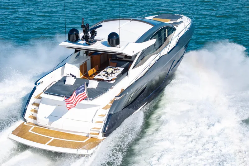 Slide: The Image of 2020 Sunseeker Predator 74 yacht cruising on open water with American flag displayed. - 22