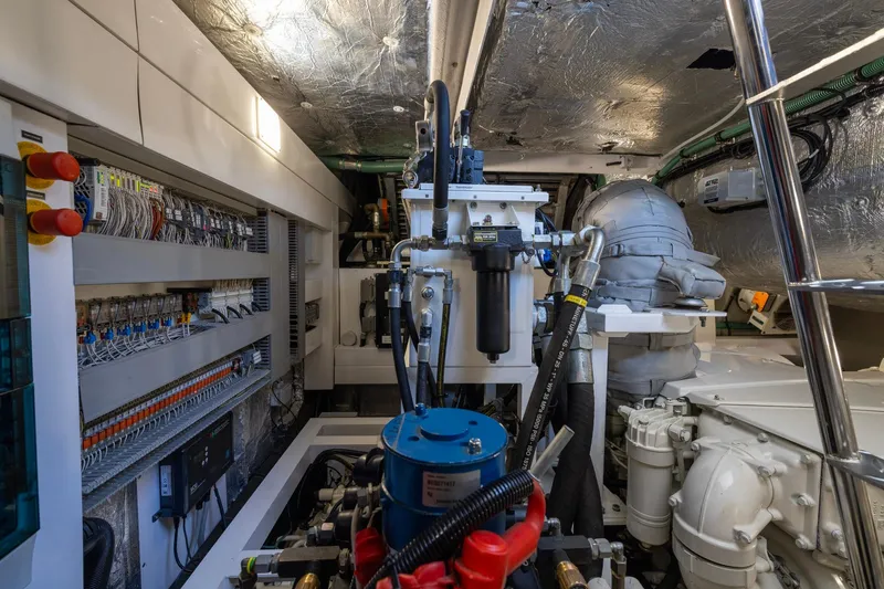 Slide: The Image of Engine room of 2020 Sunseeker Predator 74 yacht, showcasing complex machinery and wiring. - 27
