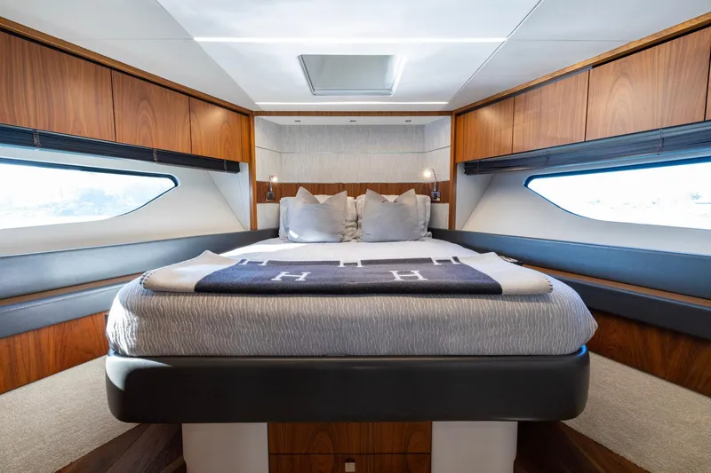 Slide: The Image of Luxurious bedroom interior of 2020 Sunseeker Predator 74 yacht with modern design and wood accents. - 32