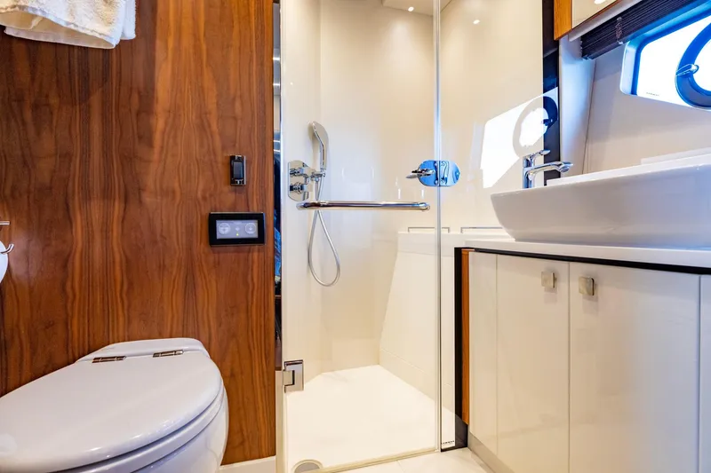 Slide: The Image of Luxurious bathroom in 2020 Sunseeker Predator 74 yacht with modern fixtures and wood accents. - 37
