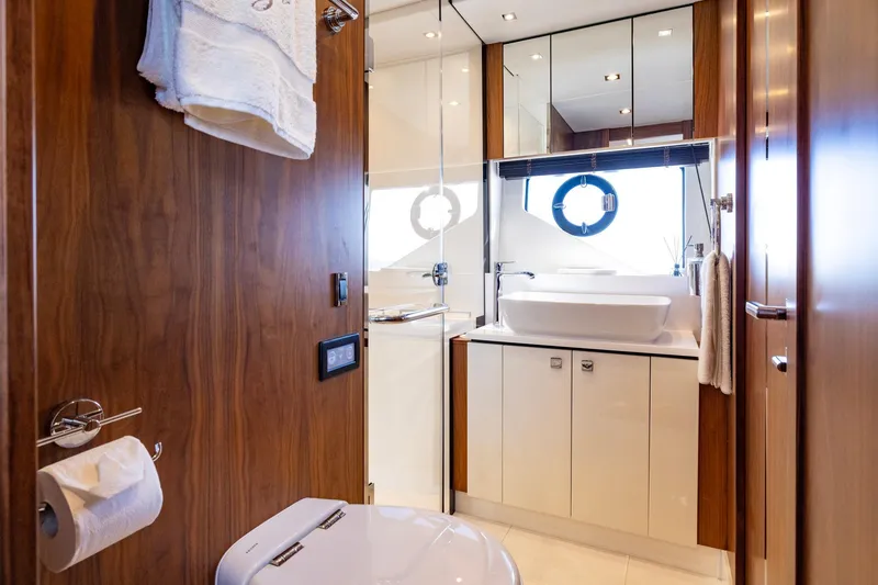 Slide: The Image of Luxurious bathroom interior on 2020 Sunseeker Predator 74 yacht, featuring modern fixtures and wood accents. - 38
