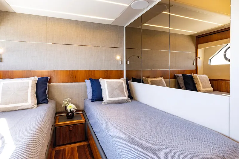 Slide: The Image of Luxurious twin cabin interior on 2020 Sunseeker Predator 74 yacht, featuring elegant bedding and decor. - 39