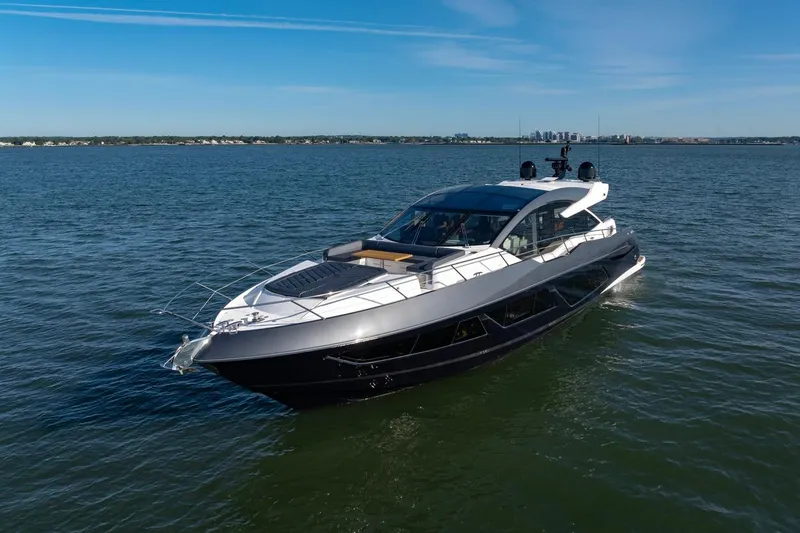 Slide: The Image of 2020 Sunseeker Predator 74 yacht cruising on open water under clear blue skies. - 4