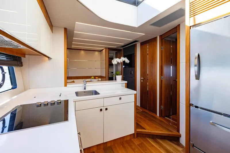 Slide: The Image of Luxurious 2020 Sunseeker Predator 74 yacht kitchen with modern design and sleek wooden accents. - 52