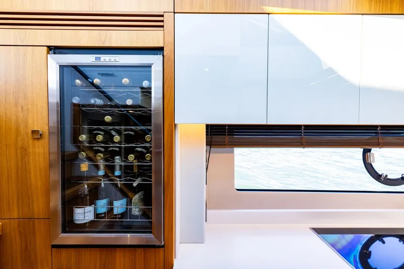 Slide: The Image of Luxurious interior of 2020 Sunseeker Predator 74 yacht with wine cooler and modern cabinetry. - 53