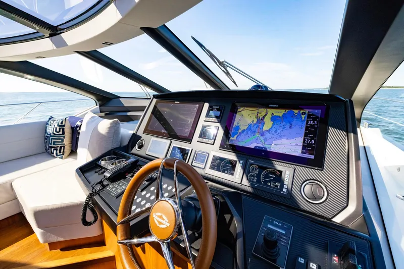 Slide: The Image of Cockpit of 2020 Sunseeker Predator 74 yacht with navigation screens and steering wheel. - 56