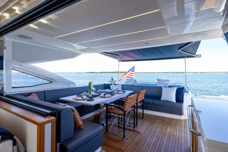Slide: The Image of Luxurious 2020 Sunseeker Predator 74 yacht with elegant outdoor dining area and scenic ocean view. - 65