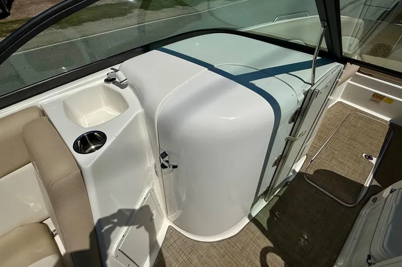 Slide: The Image of 2018 NauticStar 223 DC boat interior with seating and storage compartment. - 11