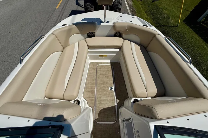 Slide: The Image of 2018 NauticStar 223 DC boat interior with beige seating and spacious layout. - 14