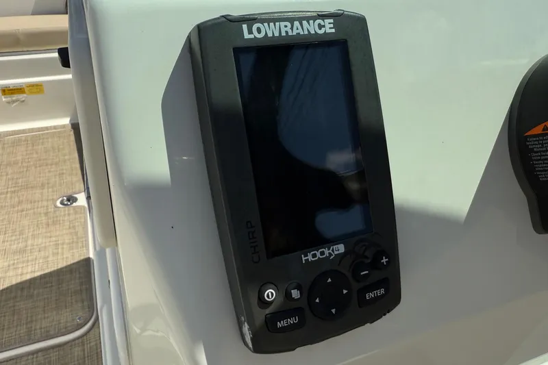 Slide: The Image of Lowrance Hook4 fish finder on 2018 NauticStar 223 DC boat dashboard. - 16