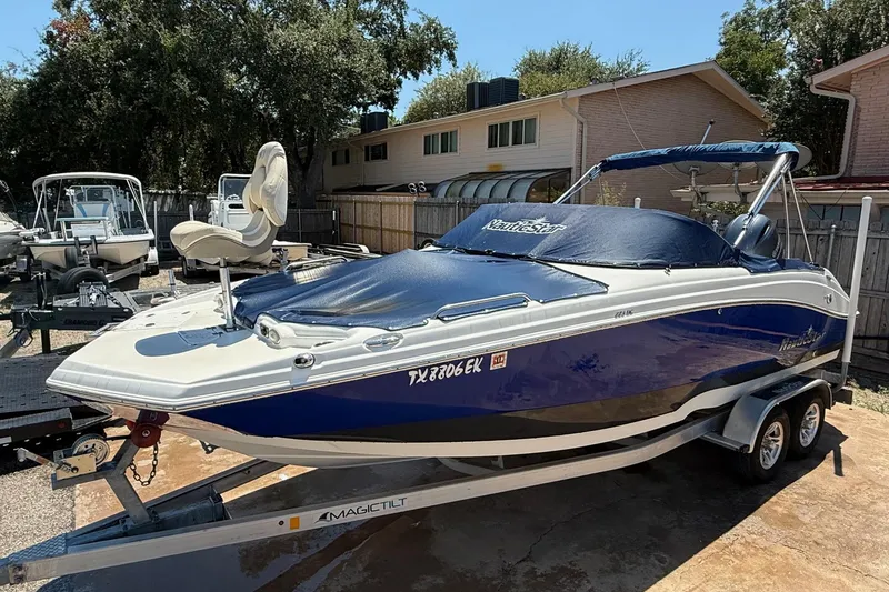 Slide: The Image of 2018 NauticStar 223 DC boat on trailer, covered and parked outdoors. - 20