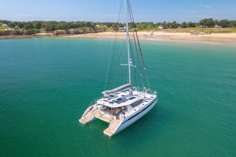 Slide: The Image of Red Privilege Signature 510 catamaran on calm water, year 2025. - 2