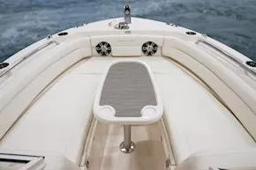 Slide: The Image of 2026 Grady-White Freedom 235 boat interior with seating and table on water. - 6