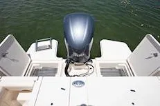 Slide: The Image of 2026 Grady-White Freedom 235 boat with outboard motor on calm water. - 7