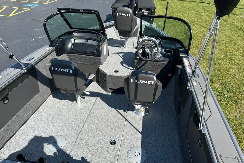 Slide: The Image of 2026 Lund 1875 Fisherman boat interior with steering wheel and seating. - 10