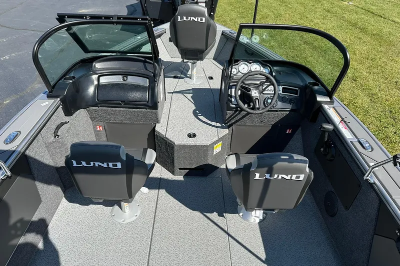 Slide: The Image of 2026 Lund 1875 Fisherman boat interior with seating and steering console. - 11