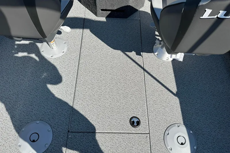 Slide: The Image of 2026 Lund 1875 Fisherman boat interior with gray carpet and seating. - 16