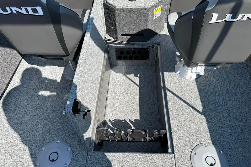 Slide: The Image of 2026 Lund 1875 Fisherman boat interior with open storage compartment and seating. - 17