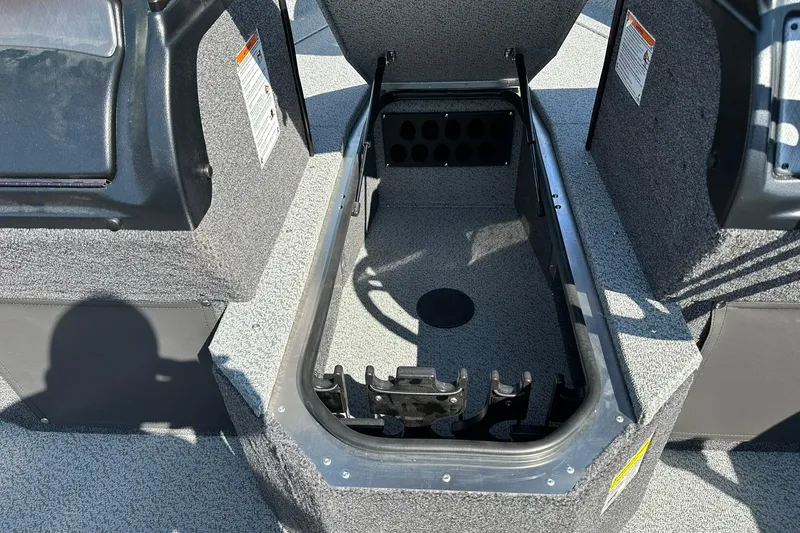 Slide: The Image of 2026 Lund 1875 Fisherman boat storage compartment with open lid, showcasing interior space. - 18