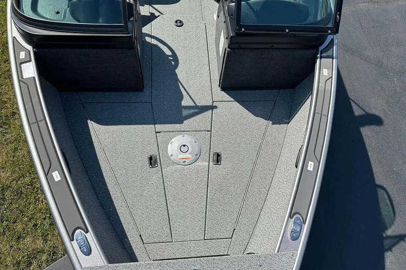 Slide: The Image of 2026 Lund 1875 Fisherman boat deck with dual consoles and carpeted flooring. - 19