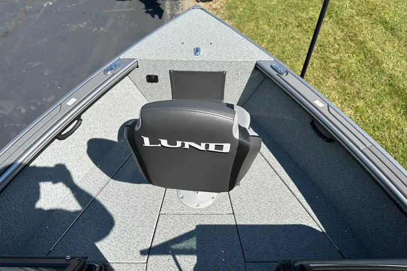 Slide: The Image of 2026 Lund 1875 Fisherman boat interior with branded seat and gray flooring. - 22