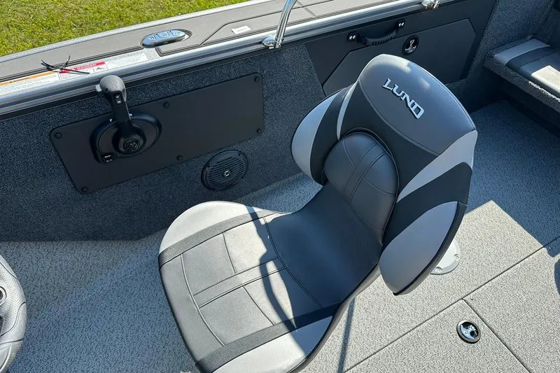 Slide: The Image of 2026 Lund 1875 Fisherman boat interior with a comfortable, branded seat and control panel. - 23