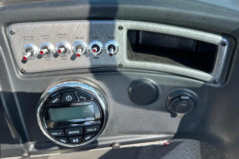 Slide: The Image of Control panel of 2026 Lund 1875 Fisherman boat with switches and audio system. - 26