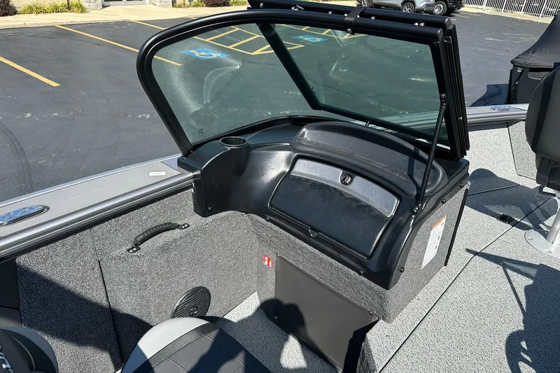 Slide: The Image of 2026 Lund 1875 Fisherman boat interior with windshield and seating, parked in a lot. - 28