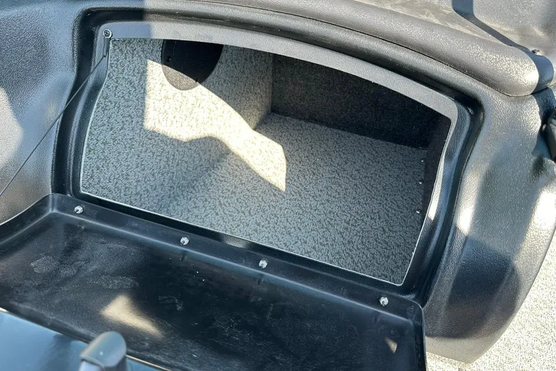 Slide: The Image of 2026 Lund 1875 Fisherman boat storage compartment with carpeted interior. - 29