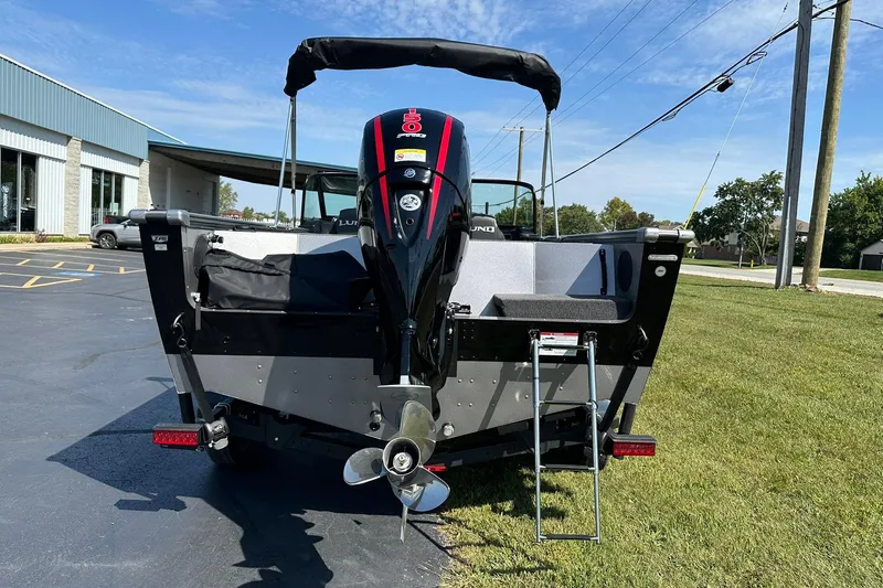 Slide: The Image of 2026 Lund 1875 Fisherman boat rear view with outboard motor and ladder. - 4
