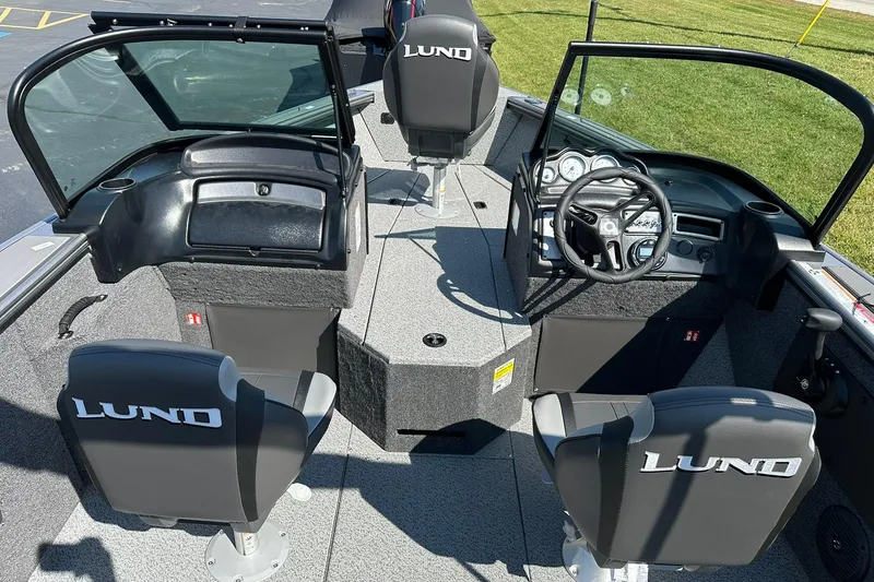 Slide: The Image of 2026 Lund 1875 Fisherman boat interior with steering console and seating. - 8