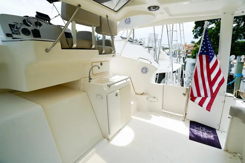 Slide: The Image of 2002 Silverton 352 Motor Yacht interior with American flag and helm station. - 10