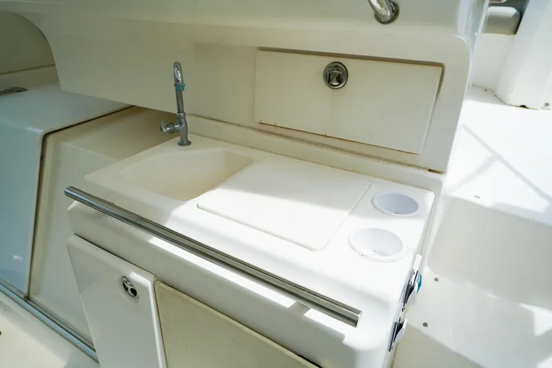 Slide: The Image of 2002 Silverton 352 Motor Yacht kitchenette with sink and storage. - 11