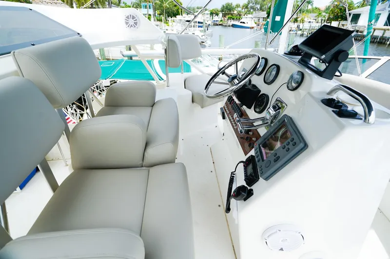Slide: The Image of 2002 Silverton 352 Motor Yacht helm with modern controls and comfortable seating. - 13
