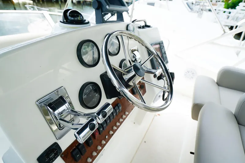 Slide: The Image of Control panel of a 2002 Silverton 352 Motor Yacht with steering wheel and gauges. - 16