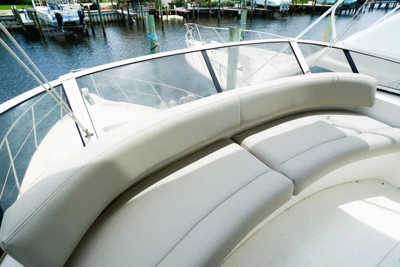 Slide: The Image of 2002 Silverton 352 Motor Yacht with curved seating, docked by the water. - 17