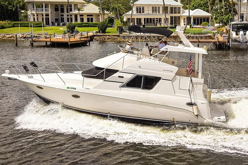 Slide: The Image of 2002 Silverton 352 Motor Yacht cruising on a scenic waterfront. - 2