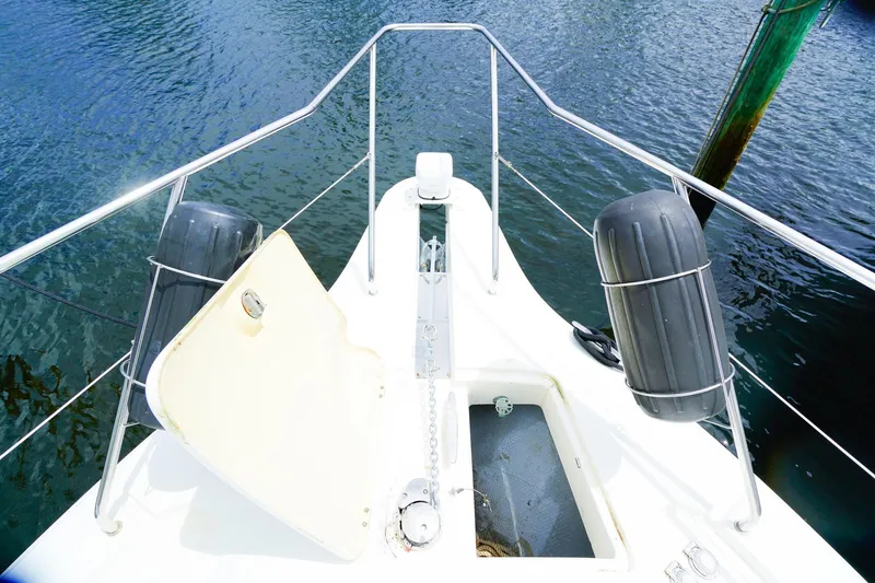 Slide: The Image of Bow view of 2002 Silverton 352 Motor Yacht with open hatch and fenders. - 24