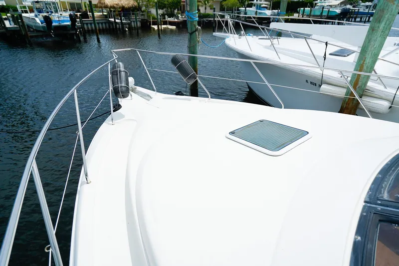 Slide: The Image of 2002 Silverton 352 Motor Yacht docked in a marina, showcasing sleek deck design. - 26
