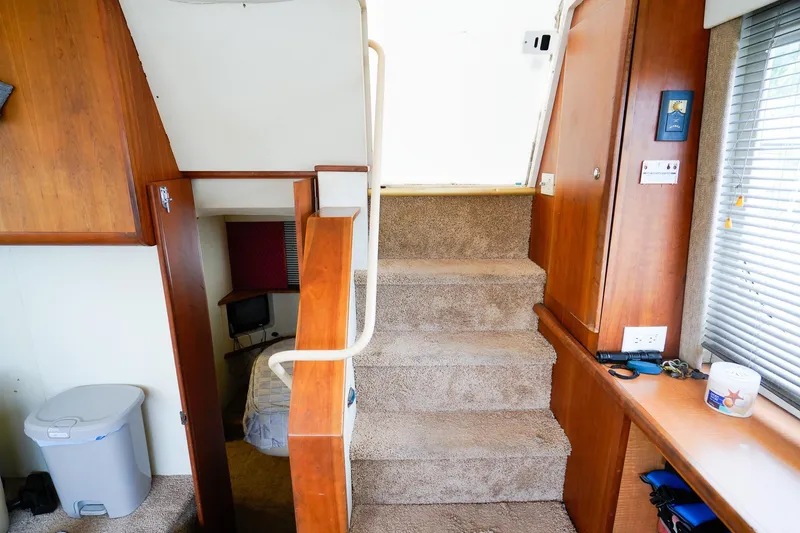 Slide: The Image of Interior of 2002 Silverton 352 Motor Yacht with carpeted stairs and wooden cabinetry. - 27