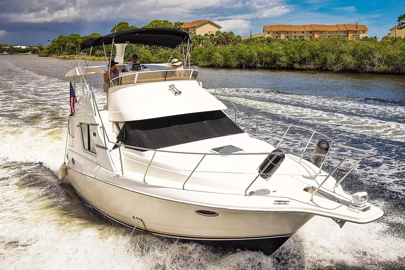 Slide: The Image of 2002 Silverton 352 Motor Yacht cruising on a scenic waterway. - 3