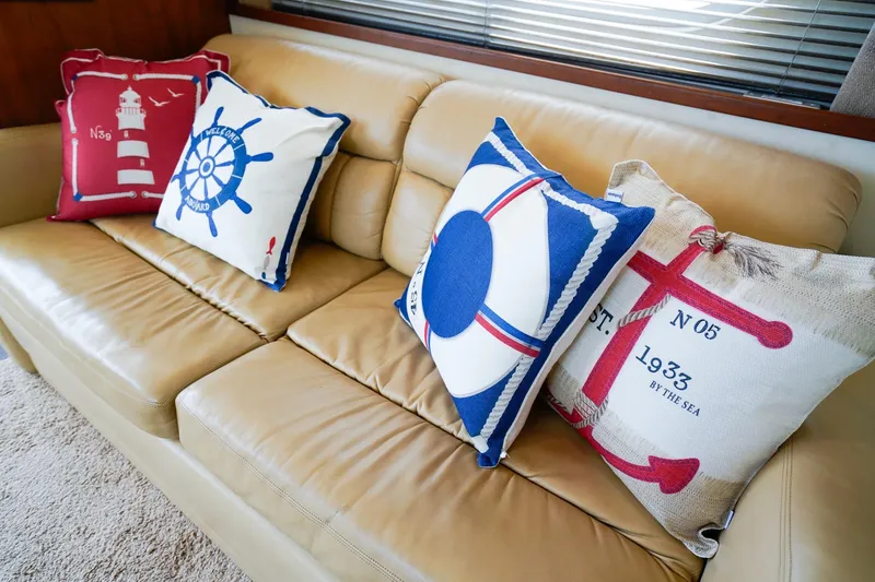 Slide: The Image of Nautical-themed pillows on a beige sofa inside a 2002 Silverton 352 Motor Yacht. - 31