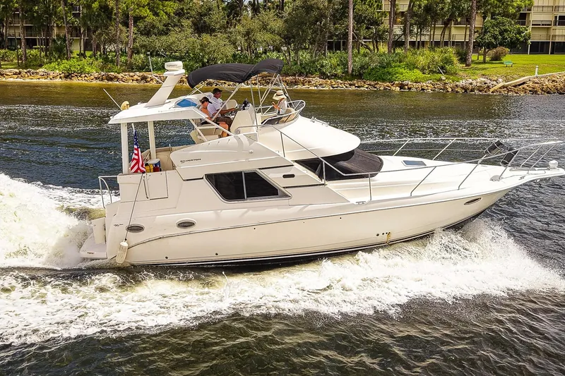 Slide: The Image of 2002 Silverton 352 Motor Yacht cruising on a scenic waterway. - 4