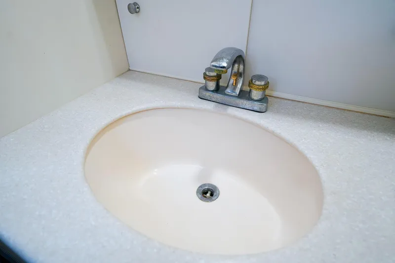 Slide: The Image of Bathroom sink in 2002 Silverton 352 Motor Yacht, featuring a classic faucet design. - 41