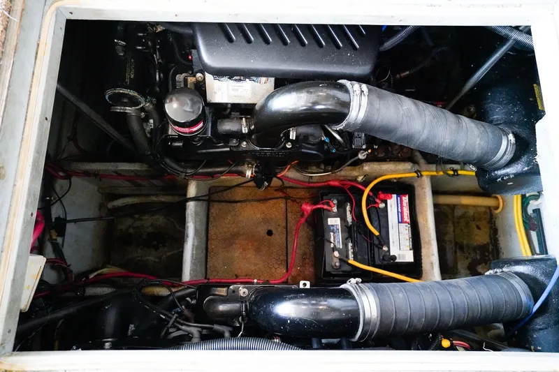Slide: The Image of Engine compartment of a 2002 Silverton 352 Motor Yacht, showing batteries and hoses. - 47