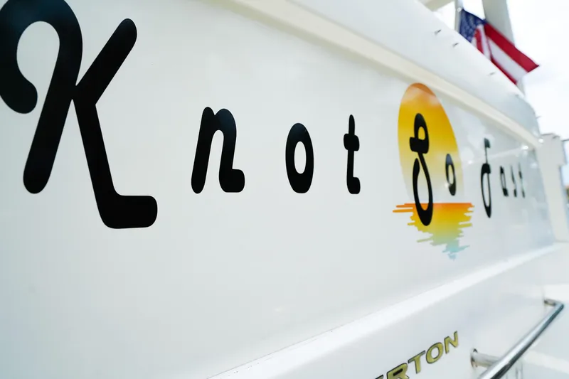 Slide: The Image of 2002 Silverton 352 Motor Yacht with "Knot So Fast" name and sunset logo. - 6