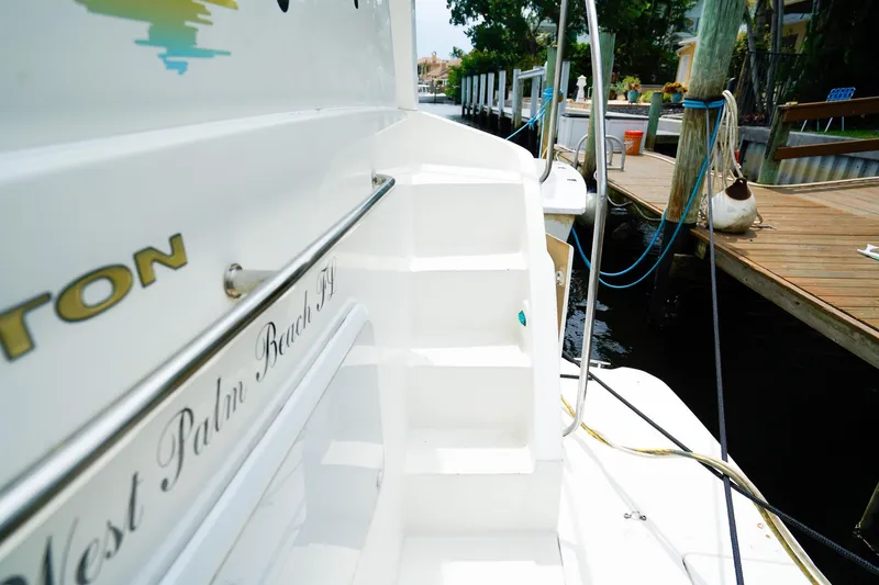 Slide: The Image of 2002 Silverton 352 Motor Yacht docked, featuring white exterior and visible staircase. - 7