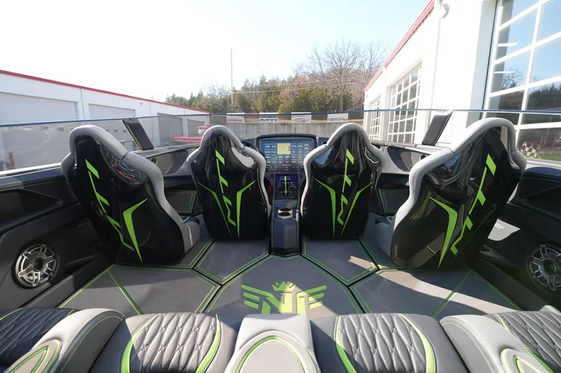 Slide: The Image of Interior of 2025 MTI 440X boat with sleek black and green seating design. - 14